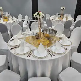 White banquet tables with gold accents and crystal floral centrepieces